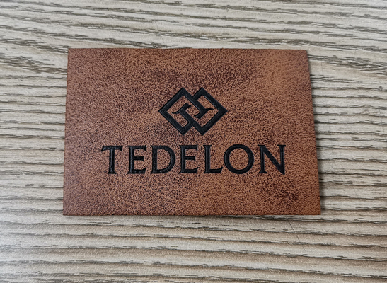 Embossed Logo PU Leather Patches Custom Color Sew On Clothing
